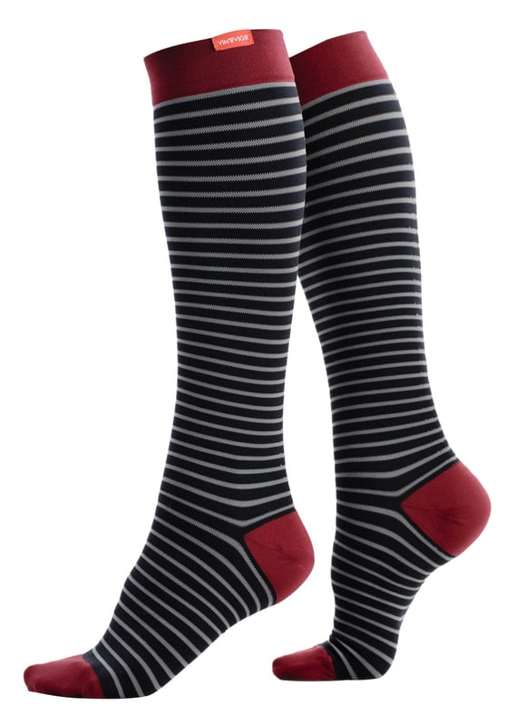Energize your legs! Using integrally-knit graduated compression, these compression socks apply therapeutic pressure that starts at the ankle and gradually eases above. It’s this external pressure that energizes your legs and Reduces Swelling. These socks have a 30-40 mmHg compression level that is ideal for all-day, everyday wear, sitting or standing for long periods. High-quality premium nylon fibers and Spandex throughout the sock allow for sustained compression throughout the day. Alleviate achiness & heaviness by squeezing the legs from the bottom up, our legwear can help increase circulation of freshly oxygenated blood back to your legs. These are made for people with circulation problems and also ideal for flight travel, pregnancy, exercising, when sitting or standing for long periods of time and even during visits to hospital. These socks are specially designed to energise legs, reduce swelling, alleviate achiness & heaviness and to aid in muscular recovery. The specially designed fabric nylon and The 400-needle count gives supreme comfort and flexibility which contours leg and heel for superior fit. These socks are comfortable and breathable with graduated compression from ankle to calf with a contoured leg and heel for a great fit. The flexible toe pocket doesn’t squeeze the toes! They are also the extra wide style to fit comfortably around the wider legs and calves. Tested & Trusted: Based out of Missoula, Montana, VIM & VIGR is dedicated to creating products that provide you with everyday relief. VIM & VIGR graduated compression legwear was developed in partnership with vascular surgeons and vein clinics and all products are listed with the Food and Drug Administration (FDA). These compression socks are available in Blue/Grey, Blue/Moss, Slate Blue/Maroon and 3 sizes: Small/Medium, Medium/Large and Large/X-Large. They’re made out of 91% Nylon, 9% Spandex (Latex-free) and are machine washable.