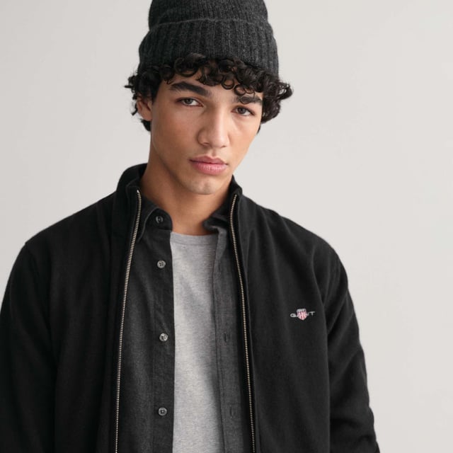 Crafted from 100% superfine lambswool  this GANT cardigan is a great addition to any wardrobe. Designed for a regular fit  it features front zip closure  side pockets  ribbed detailing at the neck  hem and cuffs and a small-scale shield graphic embroidered on the chest.