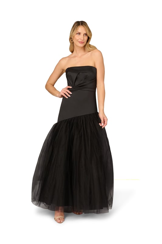 Dial up the drama during your next red-carpet appearance in this strapless gown. This formal dress features a strapless neckline, twist pleated bodice, and an asymmetrical mesh skirt. Crafted from mikado fabric, this ball gown is a nod to vintage glamor. A hidden zipper closure at the centre back completes this black-tie gown. A gorgeous look for prom or a gala, this strapless gown pairs well with simple accessories.