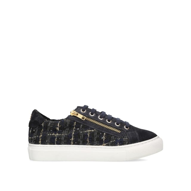 The Dulwich Zip sneaker features a navy tweed fabric upper with flecks of gold running through. The front laces up with gold eyelets to the side of a gold zip.