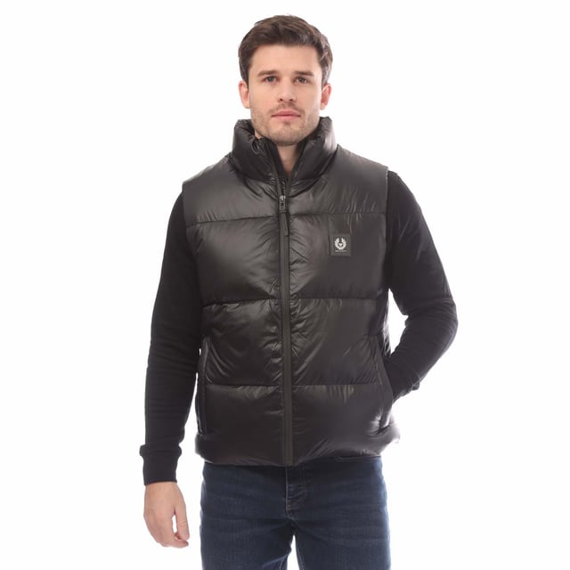Mens Belstaff Down Filled Ripstop Resolve Gilet in black.- Hood and hem drawcord.- Water resistant double centre front zip.- Zip fastening hip pockets.- Silicone phoenix badge on the chest.- Packable functionality.- 750 fill power down.- 100% RDS certified down and feather (IDFL CERT TE-00103785) with PFAS free water-repellent finish.- High-shine  100% recycled nylon in a micro ripstop construction.- High performance  lofty  ultralight and highly insulating down gilet style.- 100% Polyamide.- Ref: 105160BLACK