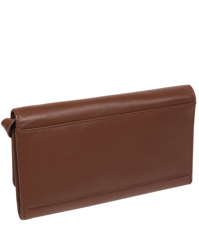 The 'Saffron' cross body clutch bag from the Pure Luxuries Marylebone collection is handcrafted from high-quality, genuine Nappa leather with a natural super-soft touch. The minimalistic fold-over top is secured by a gold-coloured magnetic press stud. The interior is lined with 100% cotton and features slip pockets and card slots to help keep an organised bag. Comes with an adjustable slim leather strap with a maximum drop length of 65cm. The strap is also removable by releasing the two interior press studs, transforming the bag into a clutch bag. Furnished with gold-coloured metal fittings. The minimalist Pure Luxuries logo is embossed in gold foil for a beautifully simple finishing touch.