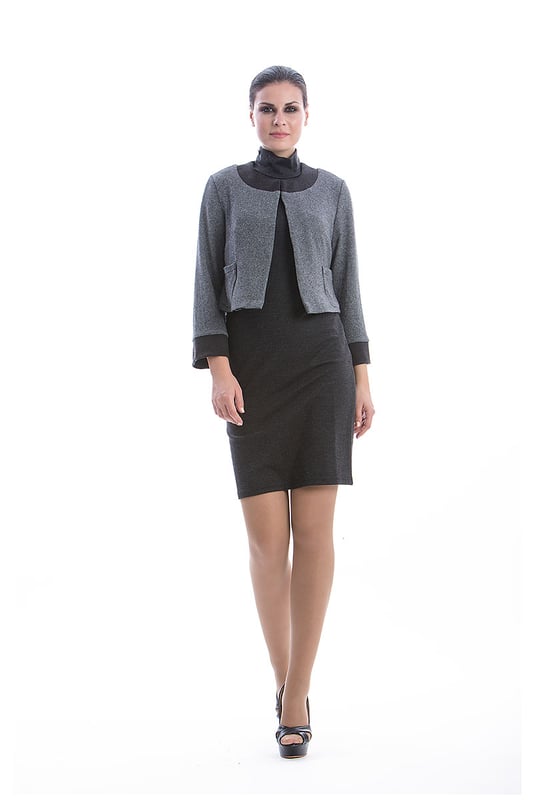 Bolero CONQUISTA in grey knit fabric. Dark grey contrast fabric on the front pockets, cuffs and neckline. Long sleeves and open in the front. To the waist in length. Stretch polyester lining. The model is 1.77m and is wearing size 36/S.
 49%viscose-34%acryl-11%wool-4%cashmere-2%elastan.