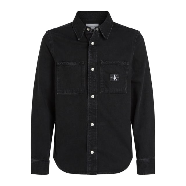 Mens Calvin Klein Logo Patch Denim Shirt in black.- Classic collar.- Front press-stud fastening.- Two chest flap pockets.- Press-stud fastening cuffs.- Faded effect.- Curved hem.- Ref: J30J3258951BY