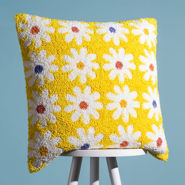 Add some fun flower power to your home with this amazing loop tufted cotton Daisy cushion. Featuring cute white daisies with different coloured centres and set on a vibrant yellow background, this bold design creates a fun, friendly and retro fashion piece. Finished with a plain polycotton canvas reverse, knife edged trim and zip fastening. A great way to create your own style in a new living space.  Size: 45 x 45cm