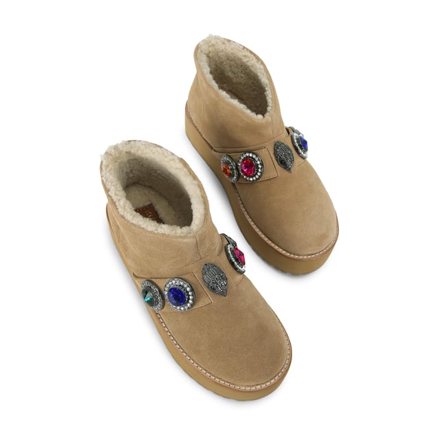 This Kurt Geiger Octavia Teddy Bootie is crafted from a soft beige suede. There is a statement strap going across the ankle which features multi-colour crystals. The sole is pumped up for extra impact.