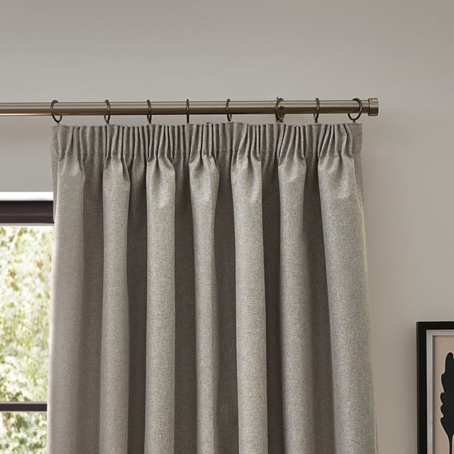 Transform your living space with Dawn Blackout Pencil Pleat Curtains, designed for those who value elegance and practicality. Crafted from soft-textured fabric with a modern marl effect, these curtains add refined style to any room while effectively blocking out light. Perfect for a restful night's sleep or creating the ideal movie-watching environment, their temperature-regulating properties ensure comfort year-round by keeping your home cool in summer and warm in winter. Enjoy the perfect blend of function and style with Dawn Blackout Curtains.