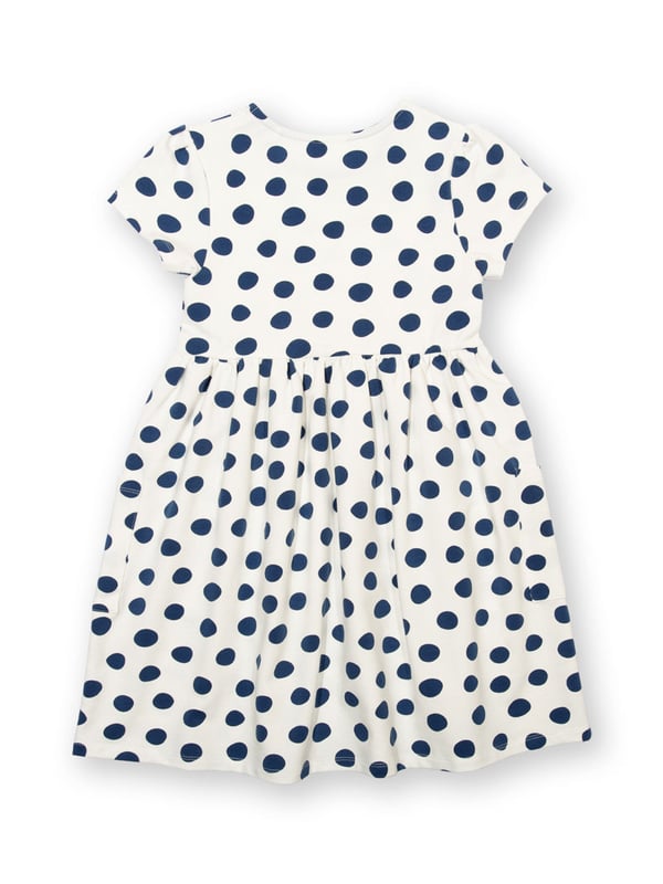 95% organic cotton 5% elastane | Proud to be certified to the Global Organic Textile Standard (GOTS) | Big spot all-over print | Cream and navy blue | French terry loop back fabric (240-250 gsm) | Coconut button shoulder opening (up to and including size 3 years) | Patch pockets | Short sleeved | Round neck | Made in Turkey | Machine washable at 40 degrees, or at 30 degrees to be kinder to the planet