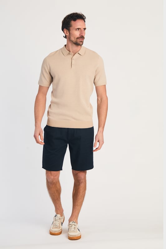 This textured polo shirt from Kensington Eastside blends classic sophistication with modern design. Crafted from a premium knit fabric with a subtle pattern, it offers a refined yet contemporary look. Lightweight and breathable, it’s a versatile choice for smart-casual occasions, ensuring style and comfort effortlessly. Made from 100% Cotton.