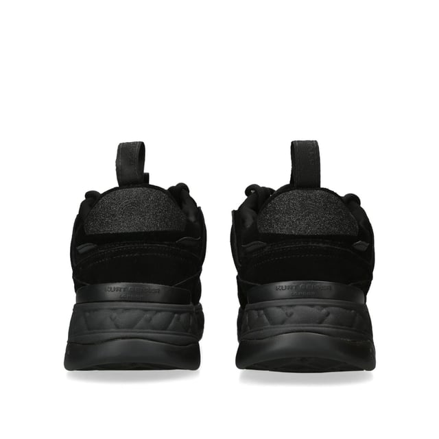The Kurt Geiger Kensington Sneaker features a black upper in suede, satin and rubber. The tongue features a black branded monocle with black eagle head. Sole height: 4cm.