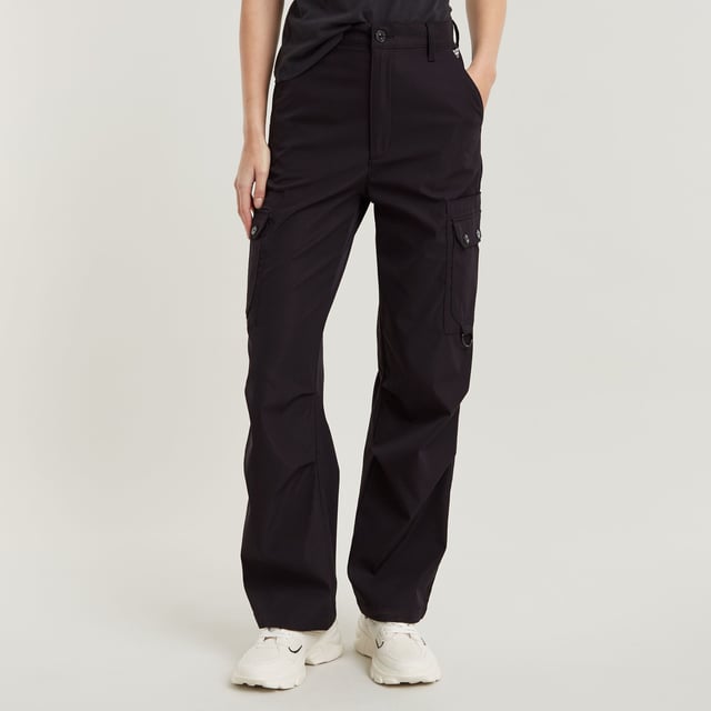 Zip fly. Inset pockets. Welt pockets at the back. Thigh pockets with additional flap pockets on top, snap buttons. Key ring at one of the thigh pockets. Zip & button closure. Ultra-high waist. Cargo pants High Waist are designed in a straight fit and offer an ultra-high waist. Pleats at the outer leg add more shape to this design. The pockets at the thigh show additional flap pockets on top. A key ring is added to one side. 65% Polyester (Recycled), 35% Elastomultiester. Comfortable stretch. Straight
