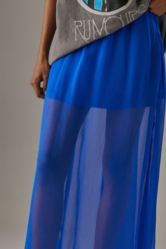 High-waisted design for a flattering silhouette
        Chiffon fabric offers a lightweight, flowing texture
        Maxi length with a short lining for coverage and comfort
        Semi-sheer overlay creates an ethereal look
        Versatile piece suitable for various occasions
    
    This chiffon high-waisted maxi skirt from Warehouse is a stunning addition to any wardrobe. The flowing silhouette and semi-sheer overlay create a captivating, ethereal effect that's perfect for formal events and special occasions. Style it with a crisp white blouse and strappy heels for a sophisticated look at weddings or garden parties. For a more relaxed ensemble, pair it with a fitted crop top and flat sandals for a chic daytime outfit. The short lining provides modesty while maintaining the skirt's airy feel. Accessorise with delicate jewellery to complement its feminine charm. This versatile piece transitions seamlessly from day to night, making it an essential for the fashion-forward woman who values both style and comfort.