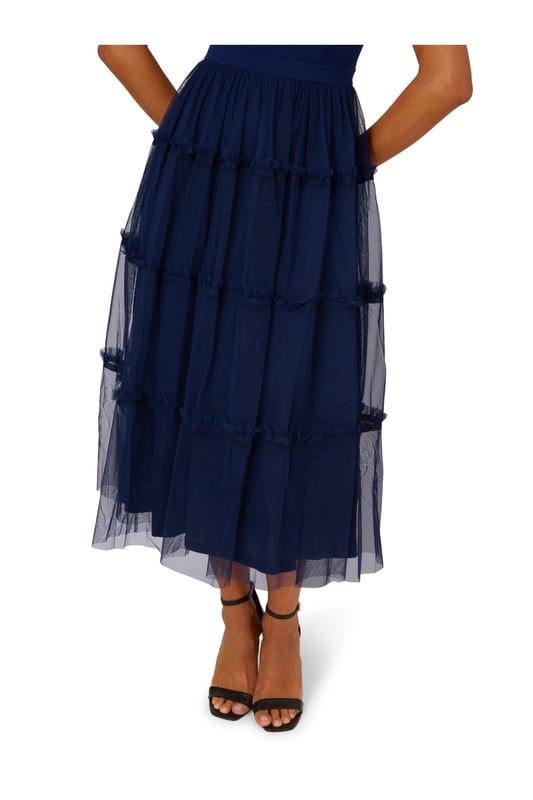 Modern fabric mixes make this classic fit and flare dress a sweet look. This midi dress features a fitted bodice with tank straps, a square neckline, and a tiered skirt. Fully lined, the bodice is crafted from a knit fabrication while the skirt is overlaid in mesh for added sweep. Pockets and a square back with centre zip closure complete this delightful party dress. Styled with nude heels and sparkling accessories, this midi dress is a timeless look from wedding guest duty to cocktail parties