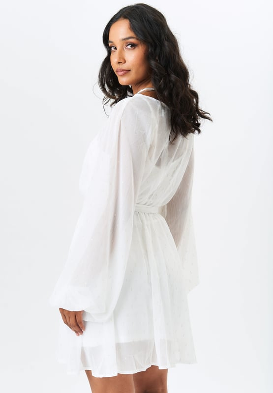 Make a fashion statement in our Long Sleeve Chiffon Foil Mini Dress. The lightweight chiffon fabric and long sleeves make it perfect for any season, while the foil detailing adds a touch of sophistication. Elevate your style with this trendy mini dress.