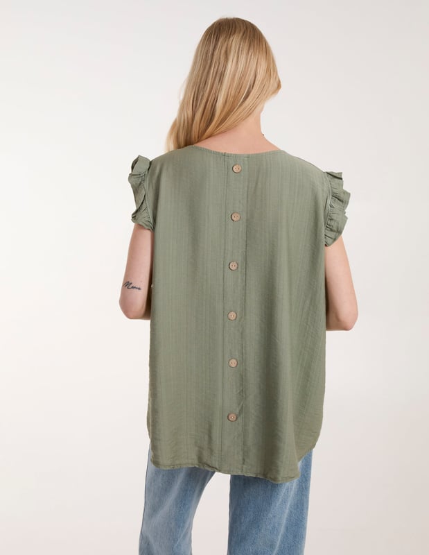 Go for comfort this summer with this Button Back Frill Shoulder Top. Pair with jeans, strappy heels and a headband for an easy day to night look!