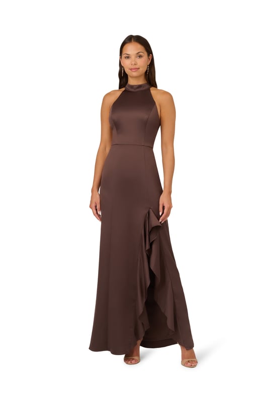 Fall for dreamy fabric and details when you select this satin mermaid gown for your next occasion. This formal dress features a sleeveless halter bodice, mock neckline, and a mermaid skirt with a slit trimmed with ruffles. Designed with satin fabric, the bodice of this formal dress has princess seams for a fit that flatters your figure. A self-tie neck adorns the cutout back and a hidden zipper closure at the centre back completes this evening gown. Paired with statement jewellery and metallic heels, this sleeveless satin gown will shine for formal and black-tie events.