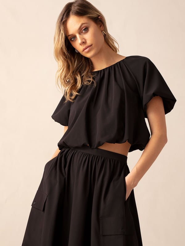 Co-founders' Notes

Introducing the Parachute Top, a relaxed fit with a subtle bubble hem and soft volume short sleeves. This lined style features a discreet zip at the back neck for added convenience. Crafted from lightweight fabric that feels effortlessly comfortable, this shorter length top pairs seamlessly to the waistband of our matching skirt for a laid-back and coordinated look.

Lined

Zip at back neck
Short length top
Relaxed fit. Try your usual size



Fabric &amp; Care



Composition: Main: 92% Polyester 8% Elastane Lining: 100% Viscose


Garment Care: Machine washable



Size &amp; Fit


Relaxed fit. Try your usual size

Length: 46cm (size 10)

Model is 170 cm/5'7" and is wearing a size 10