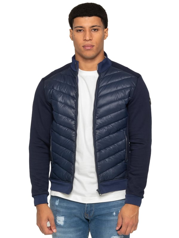 Enzo Milano Mens Hybrid Jacket features a puffer front made from lightweight polyester, which provides excellent insulation. Full zip fastening front with a elasticated collar, long contrast-fabric sleeves with elasticated cuffs. The jacket has 2 secure zip-fastening pockets, 2 inside pockets for additional storage. Finished with Enzo Milano rubberised branding on the left sleeve.
