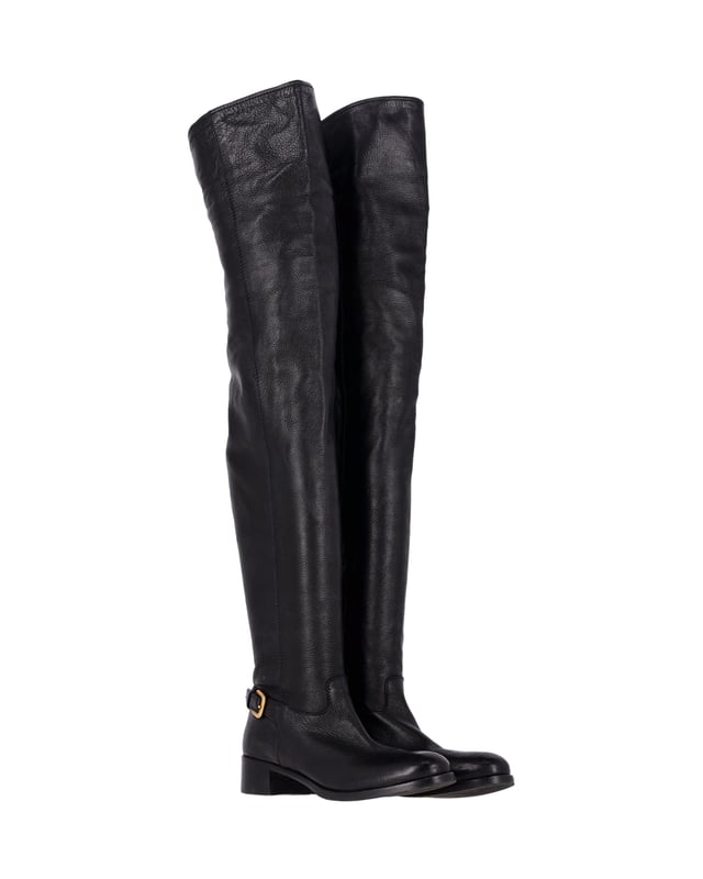 VINTAGE, RRP AS NEW
Step into style with the Prada Over-The-Knee Buckled Boots. These boots are crafted from soft and supple black leather, offering both comfort and luxury. The over-the-knee length creates a striking silhouette. With a low block heel and round toe, these boots boast a practical design. The gold-tone buckle on the side adds a classic and subtle detail, making these boots perfect for any occasion.

Prada Over-The-Knee Buckled Boots in Black Leather
Condition: Very good
Sign of wear: Moderate wear on the soles, minor creasing
Material: Leather
Color: Black
Size: IT37 / US7 / UK4
SKU: 360946 / HNPUGBSH360946W