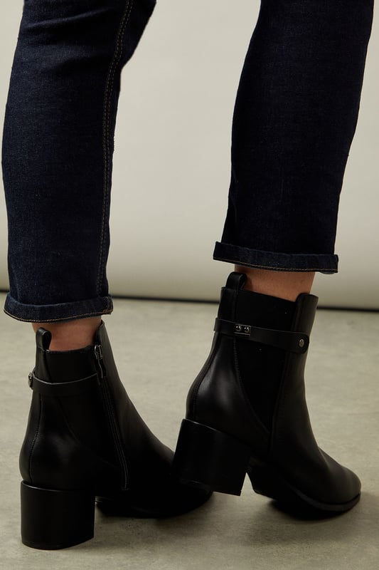 Wide fit design for enhanced comfort
        Elastic gusset for easy slip-on
        Medium block heel measuring between 5 and 6.5cm
        Sleek ankle-length silhouette
        Versatile day-to-night style
    
    Step out in style and comfort with these sophisticated Ahio ankle boots from Wallis. Crafted with a wide fit and featuring an elastic gusset, these boots offer both ease and elegance. The medium block heel, measuring between 5 and 6.5cm, provides a perfect balance of height and stability. Ideal for the woman who values both fashion and function, these boots transition seamlessly from day to night. Pair them with tailored trousers and a crisp blouse for a polished office look, or style them with a flowing midi dress for an evening out. The versatile design makes these boots a wardrobe essential, suitable for various occasions from casual outings to more formal events. With their timeless appeal and practical features, these Wallis boots are set to become your go-to footwear for any season.