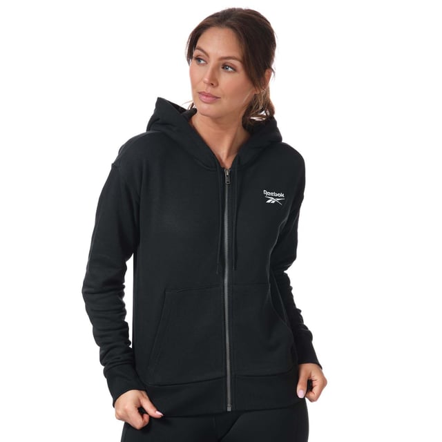 Womens Reebok Identity Zip- Up Track Top in black.- Drawcord-adjustable hood.- Long sleeves with ribbed cuffs.- Full zip fastening.- Kangaroo pocket.- Ribbed hem.- Small logo.- Oversize fit.- Main Material: 80% Cotton  20% Polyester (Recycled). Rib Part: 95% Cotton  5% Elastane. - Ref:GL2561