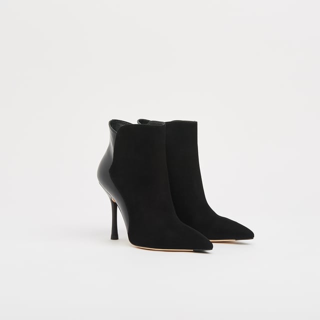 A sexy new style in our autumn/winter shoe collection, our Aliyah ankle boots have incredible shape. Crafted in Spain from a stylish blend of black suede and nappa leather, they have pointed toes, inside zips and 100mm slender heels with flared detail. Sophisticated and stable, wear them with autumn's midi dresses and sleek tailoring alike.