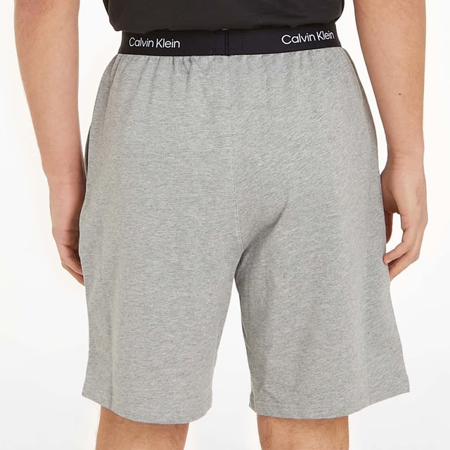 Mens Calvin Klein Sleep Shorts in grey.- Branded waistband.- Side pockets.- Engineered branding.- Regular fit.- Ref: 000NM2417P7A