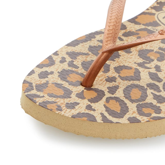 Create a glam beachside look in Havaianas' snake print design. Black, lilac and rose with metallic straps and slight wedge sole. Made in Brazil with non-slip finish, heat and water resistant.