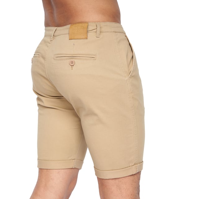 98% Polyester, 2% Elastane. Fabric: Canvas, Stretch. Design: Logo. Pockets: 2 Side Pockets, 2 Back Pockets, Jet Pocket, Buttoned. Fastening: Button, Zip Fly. Style: Chinos. Back Yoke, Belt Loops, Darted, Gripping Inner Waistband, Mock Horn Buttons, Self Fabric, Twin Needle Stitch.