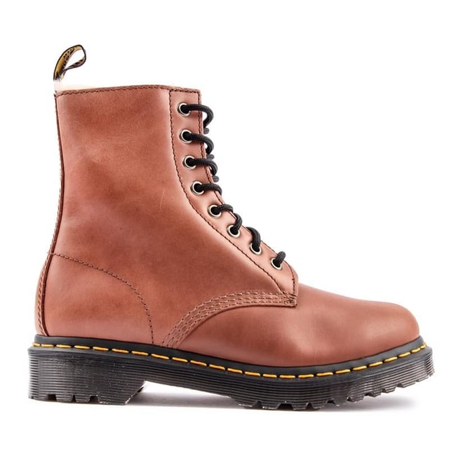 The Women's Brown Dr. Martens 1460 Serena Ankle Boots Bring It To The Point - Timeless, Stylish, Alternative, With A Premium Leather Upper, A Warm Faux Fur Lining And Sock, The Iconic Yellow Stitching And The Famous Air-cushioned Airwair Sole, Which Gives Them The Real Doc Martens Edge. Featuring Goodyear Welt And A Rugged Treat For Enhanced Durability And Sturdiness. These Boots Definitely Stand Out From The Crowd.