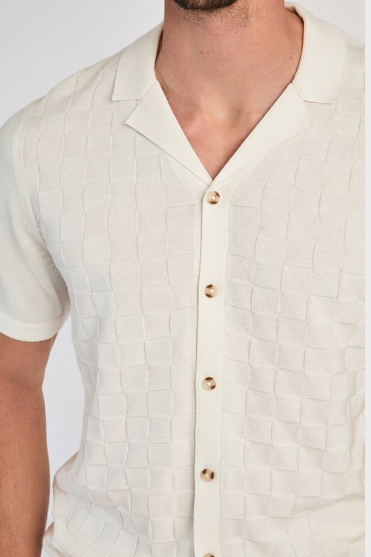 This knitted shirt from Kensington Eastside is a perfect mix of style and comfort. With a subtle checked pattern on the front and a laid-back Cuban collar, it’s an easy go-to for smart-casual outfits. Lightweight and breathable, it’s great for any occasion where you want to look sharp with minimal effort.
