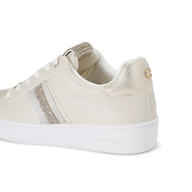 This Carvela Rapid trainer features a gold upper with metallic toe and heel panels. The tongue is embellished with rose gold crystals. The front laces up with gold tone branding details.