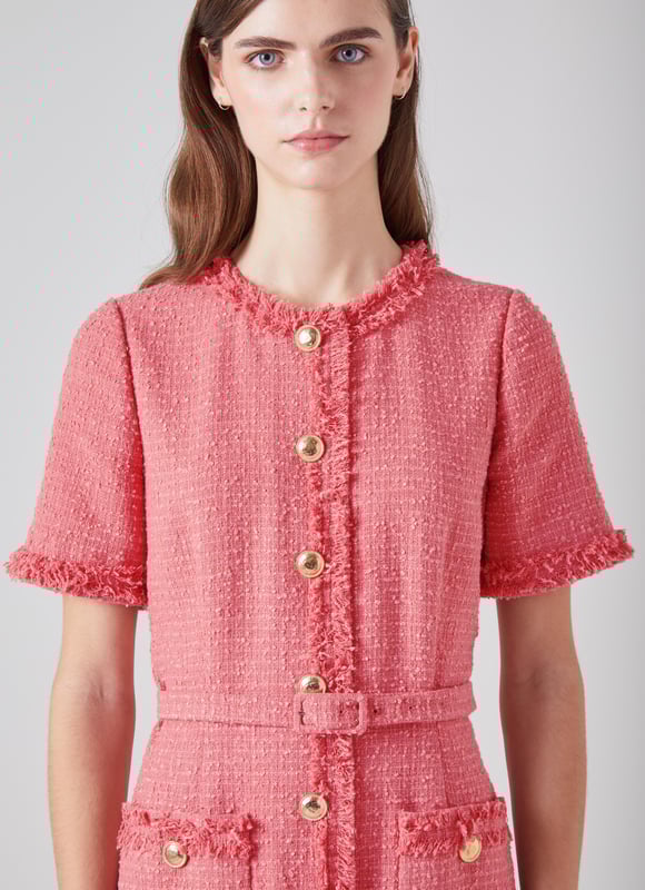LK Bennett Allie Dresses, Blush The little tweed dress is a wardrobe classic, it will never fall out of style. Our new Allie dress is crafted in Europe from dark pink Italian tweed using recycled cotton, and is a short shift with a round neck, a raw edge trim, short sleeves, single-breasted hammered gold buttons, a fabric buckle belt and patch pockets on the skirt. Super chic and simple, wear it with stylish flat or a fun pair of platforms.