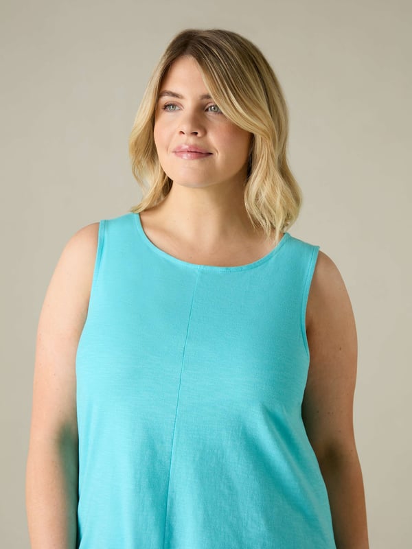 This easy-to-wear vest, cut from breathable cotton, is designed to be the most flattering piece in your wardrobe. In the softest of turquoise slub cottons, with a softly rounded neckline and a centre front seam to give a gentle A-line silhouette to the body, its nice and loose on the tummy, and is the perfect basic staple piece that youll come back to time and time again.