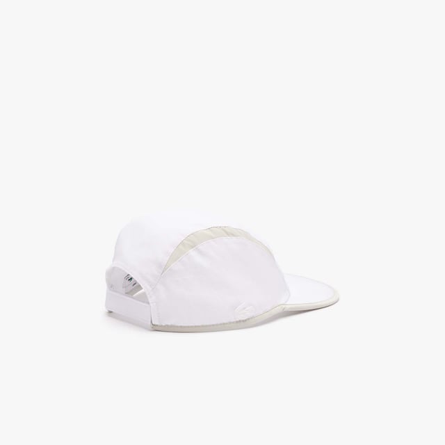 Accessories Lacoste Jockey Cap with Contrast Cutouts. ACTIVE MEETS NEO HERITAGE: SOFT AND HIGH END EXECUTIONS FOR A NEW BALANCED SILHOUETTE. Girolle active light visor with contrasted cuts on top and contrasted piping detail all around.- Recycled taffetas and recycled ripstop.- Unisex Taffetas lining inside.- Ajustable velcro back closure.- 2.5 cm silicone crocodile. Material: 100% Polyamide. Ref: RK1486IZ9.