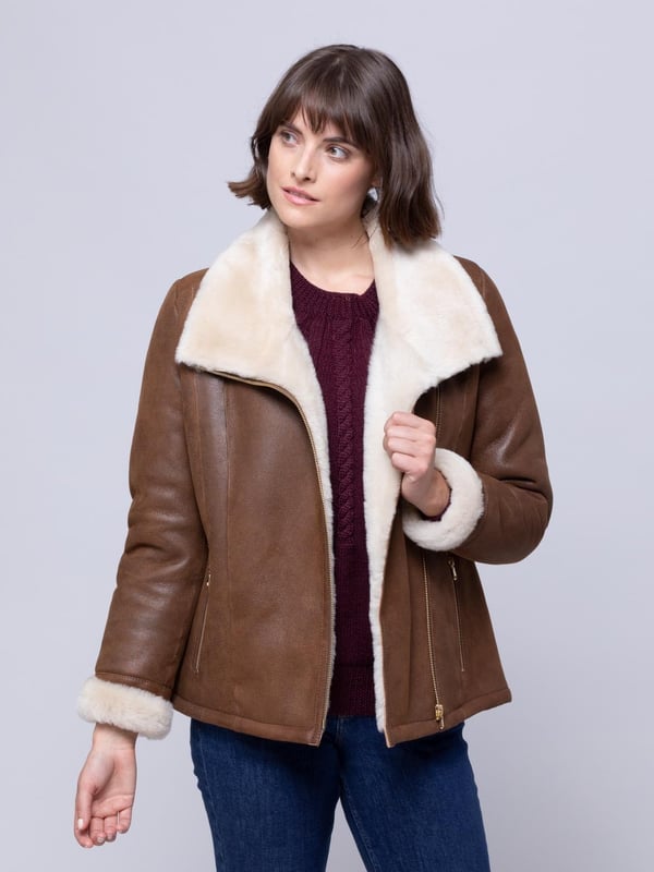 Allerdale Sheepskin Aviator Jacket in Caramel For those wanting to add a little extra glamour to their sheepskin aviator, the Allerdale offers just that. We've taken the classic style, in a rich-caramel hue, and added gold-toned hardware, to elevate the Allerdale. Hand-crafted from 100% sheepskin, this aviator has a nappalan finish, and in time it will develop a crackled vintage effect. Combined with a contrasting white wool, showcased on turn-back cuffs and a chunky collar, this is a distinctive jacket. The styling is incredible, yet nothing should take away from the sheepskin. After all these years it remains our favourite material, offering the perfect balance between form and function. As nature's ultimate insulator it's the first jacket you'll turn to when the temperatures drop. And, it will be with you for years to come.