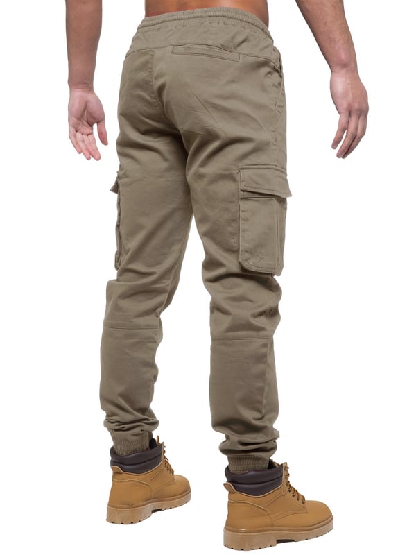 Enzo Mens Elasticated Waist Stretch Cuffed Jeans. Features a 5 Pocket Design. 2 Slash Pockets, 1 Back Pocket 2 Front Cargo, Bellow Side Pockets With Velcro Fastening. Elasticated Waist With Adjustable Drawstings. Cut and Sew Design On Leg. Cuffed Ankle