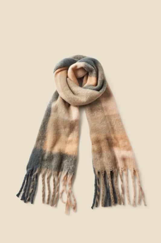 Wrap up in style Spun from luxuriously soft fabric for serious warmth Long length for maximum cosiness Checks are always on-trend Neutral tones make it so versatile Throw on with a biker or a chic longline coat