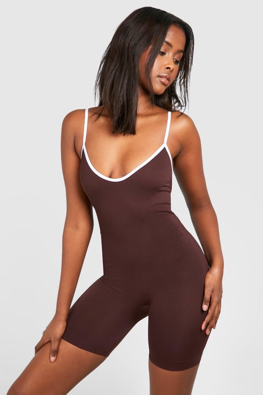 Seamless construction for ultimate comfort
        Scoop neckline with contrasting trim
        Figure-hugging silhouette
        Short length for a playful look
        Versatile design for various casual occasions
    
    Embrace effortless style with this seamless short contrast playsuit from Boohoo. Perfect for the fashion-forward woman who values both comfort and trend-setting looks, this piece is a must-have for your casual wardrobe. The figure-hugging silhouette accentuates your curves, while the scoop neckline adds a touch of allure. Style it with white trainers and a denim jacket for a laid-back daytime ensemble, or dress it up with strappy sandals and statement jewellery for a night out with friends. Its versatility makes it ideal for family gatherings, brunches, or casual outings. The contrasting trim adds a subtle pop, ensuring you stand out in the best way possible. Easy to wear and care for, this playsuit is the epitome of fuss-free fashion that doesn't compromise on style.