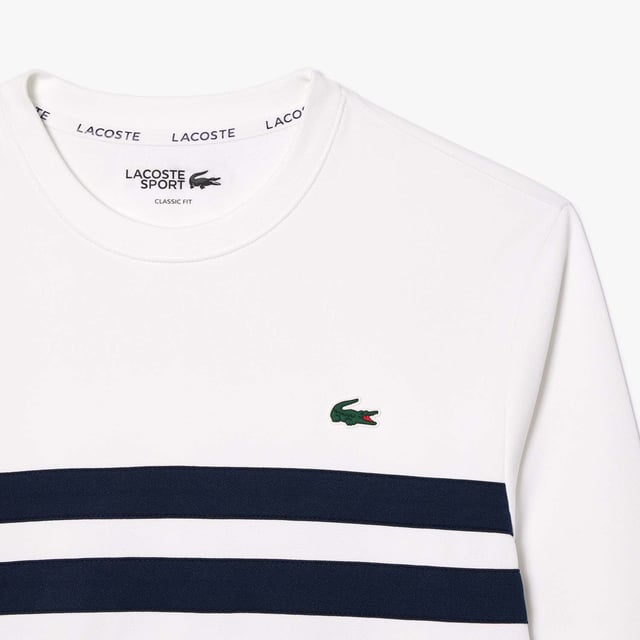 Designed for Tennis  for a regular frequency of use This product is in Interlock which guarantees you a resistant fabric making it adapted to high repetitive movements during training sessions. This sweatshirt is made in 100% recycled polyester Classic fit: comfortable ease on body  with comfortable sleeves The technical capsule offers the complete seasonal wardrobe on and off court with a strong design identity. LACOSTE wording print at back neckline.
