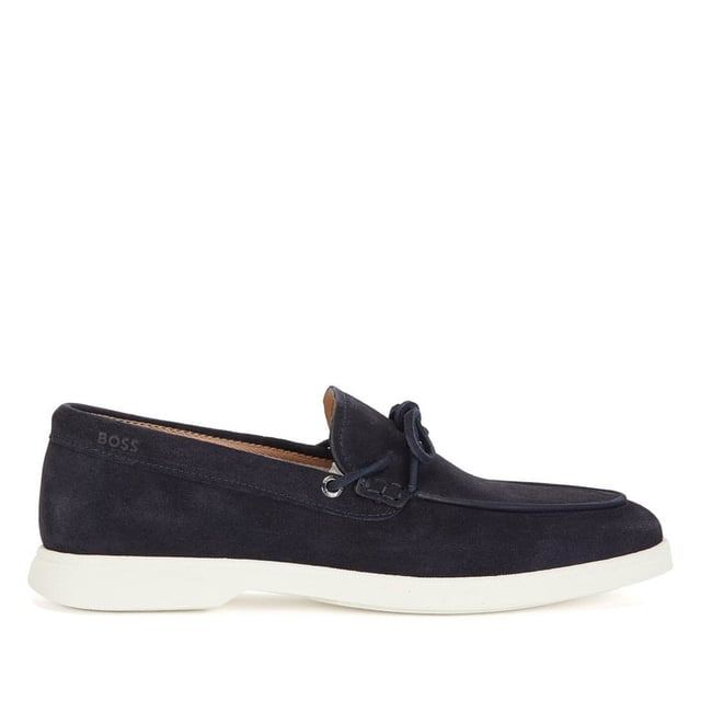 A slip on shoe with suede uppers featuring decorative tassels across the vamp in dark blue suede and all over dark blue stitch details. Two silver branded eyelets situated on the outstep and instep with the signature BOSS logo embossed on the outstep of the heel. A textured rubber midsole in off white with a branded and textured rubber undersole in off white.
