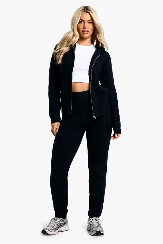 Soft Fine Guage Zip Through Hoody Knitted Tracksuit Soft fine knit fabric for ultimate comfort
Hooded top with full-length zip closure
Coordinating trousers for a complete look
Versatile two-piece set for effortless styling
Relaxed fit perfect for lounging or casual outings
Embrace laid-back chic with this soft fine knit tracksuit. The hooded top with a full-length zip offers both style and practicality, while the coordinating trousers complete the ensemble. Perfect for those lazy Sundays or running errands, this set radiates comfort without compromising on trend. Style it with trendy trainers and a baseball cap for a street-smart look, or throw on some statement jewellery to dress it up for a casual coffee date. The versatility of this co-ord allows for endless styling possibilities - layer with a puffer jacket for cooler days or wear the pieces separately to mix and match with your existing wardrobe. Whether you're heading to the gym, meeting friends for a casual brunch, or simply lounging at home, this tracksuit is your go-to for effortless, comfortable style.
