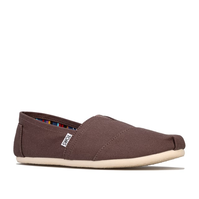 Toms Classics hereninstappers van canvas in grijs<br /><br />-Instappers<br />-Elastisch V-inzetstuk aan de voorkant voor extra comfort<br />-Rubberen EVA-buitenzool<br />-Voorgevormd voetbed voor extra demping<br />-Latex voetbooginzetstuk voor extra ondersteuning<br />- Contrasterende voering<br />-Merkdetails op de hiel en de zijkant<br />-Bovenwerk van textiel, voering van textiel en leer, zool van textiel en synthetisch materiaal<br />-Ref: 10000864