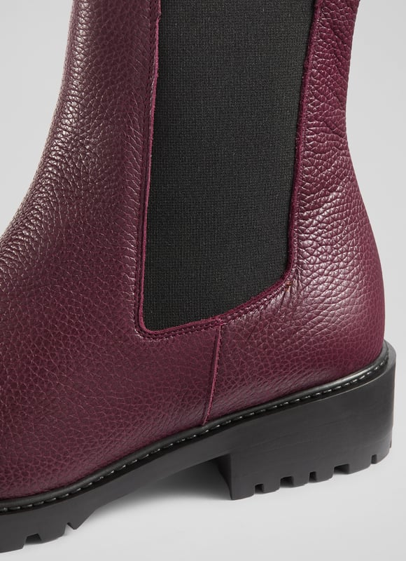 Make a bold statement with these Cadea ankle boots, perfect for casual wear. Crafted in Spain from luxurious textured leather, the tread sole boot features a round toe and a flat tread sole for ultimate comfort. These boots pair effortlessly with skinny jeans or a flowing midi dress for a stylish, versatile look.