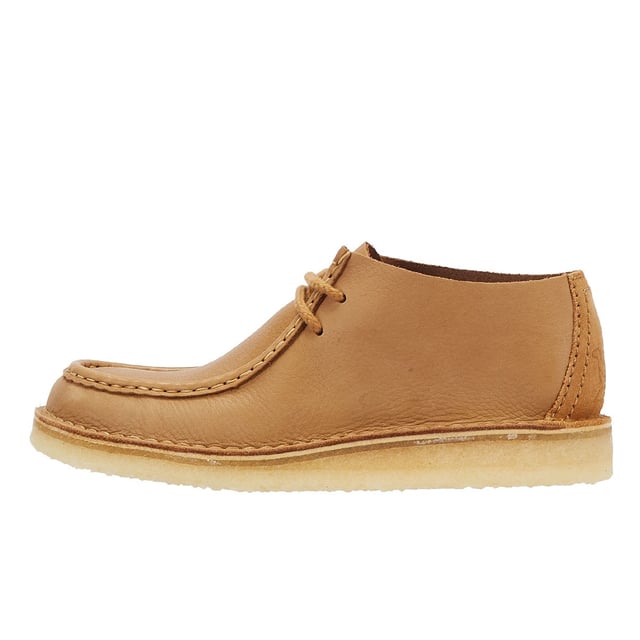 Introducing the Nomad shoe, a fusion of Wallabee and Desert Trek styles, boasting hand-stitched details. Crafted from premium mid tan leather upper for durability and style. Finished with a lightweight pebble crepe sole for added comfort and traction.