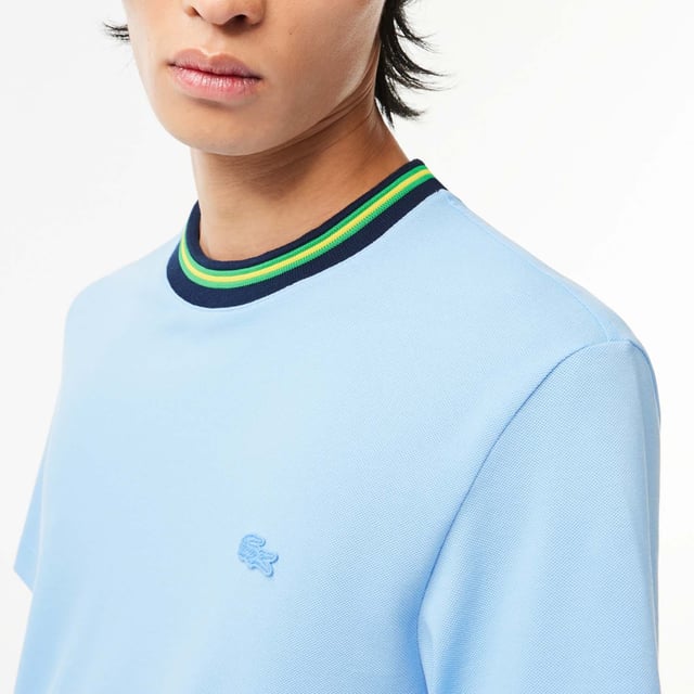 Men's Lacoste Stripe Collar Stretch Piqué T-Shirt.- Regular fit, natural ease on body.- Stretch mini pique, made of organic cotton and elastane.- Striped ribbed collar with contrasted tipping detail.- Tone on tone crocodile at chest. Material: 94% Cotton, 6% Elastane. Ref: TH1131HBP.