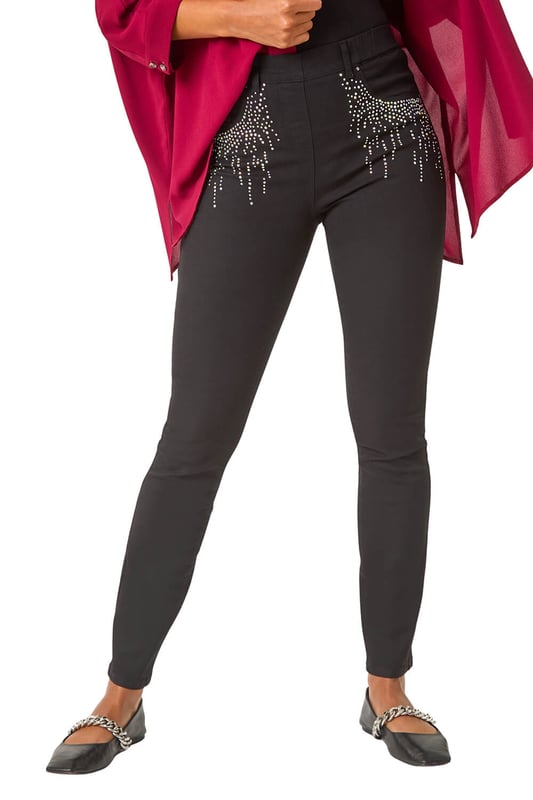 Hotfix Pocket Jegging from Roman. Add some sparkle to your denim collection with these embellished hotfix pocket jeggings. Crafted from a comfortable stretch denim fabric, these jeggings feature a pull-on style for ease and comfort. The standout hotfix pocket trim detail adds a touch of glamour to your casual look. Perfect for the Autumn/Winter season, style these jeggings with knitwear and trainers for a chic and cosy outfit!