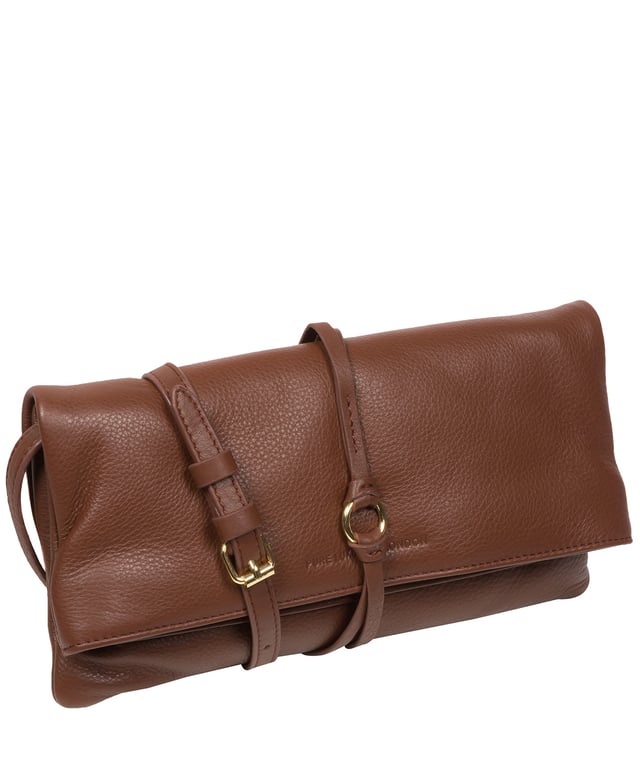 The 'Selene' cross body clutch bag from the Pure Luxuries Marylebone Collection is handcrafted from high-quality, genuine Nappa leather with a natural super-soft touch. The fold-over top secured by two magnetic press studs, opens to reveal a zipped main compartment and a slip pocket. The interior is lined with 100% cotton and includes two slip pockets to help maintain an organised bag. Comes with a matching and adjustable slim leather strap, with a maximum drop length of 65cm. The strap is also removable, transforming the bag into a clutch bag. Features gold-coloured metal fittings and zip. The Pure Luxuries logo is embossed for an effortless and sophisticated finishing touch.