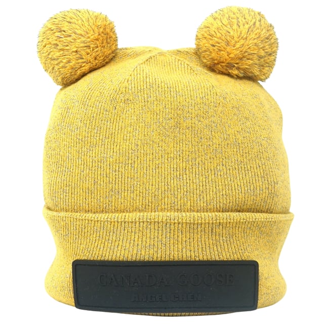 Canada Goose X Angel Chen Double Pom Toque Yelllow Beanie. This Canada Goose Logo yellow Beanie will keep you warm and stylish all season. Featuring a double pom and brand logo, it's perfect for adding a stylish touch to any winter look. Stay fashionable and cozy!. 100% Wool, Made In Italy. Stretching Fit, Angel Chen Collection, Beanie Hat. Regular Fit, Fits True To Size. Style: 8820LC 1039