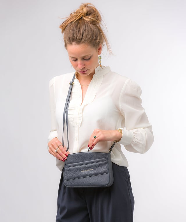 The 'Helena' cross body bag from the Pure Luxuries Marylebone collection is handcrafted from high-quality, genuine Nappa leather with a natural super-soft touch. The zip-over top opens to reveal a 100% cotton-lined interior. The spacious compartment features two slip pockets to help maintain an organised bag. A zipped pocket on the front of the bag provides on-the-go storage. Features gold-coloured metal fittings and zips alongside the adjustable slim leather strap, with a maximum drop length of 65cm. The Pure Luxuries logo is embossed in gold foil for a beautifully simple finishing touch.